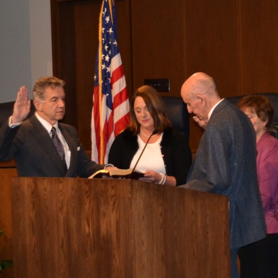 Ernie Trakas, left, is sworn in by his wife, former Mehlville Board of Education member Lori Trakas, and U.S. District Judge E. Richard Webber Jan. 1.