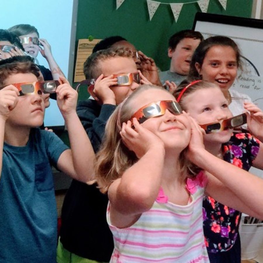 Gotsch Intermediate School third-graders in the Affton School District practice wearing their eclipse glasses on the second day of school Thursday.