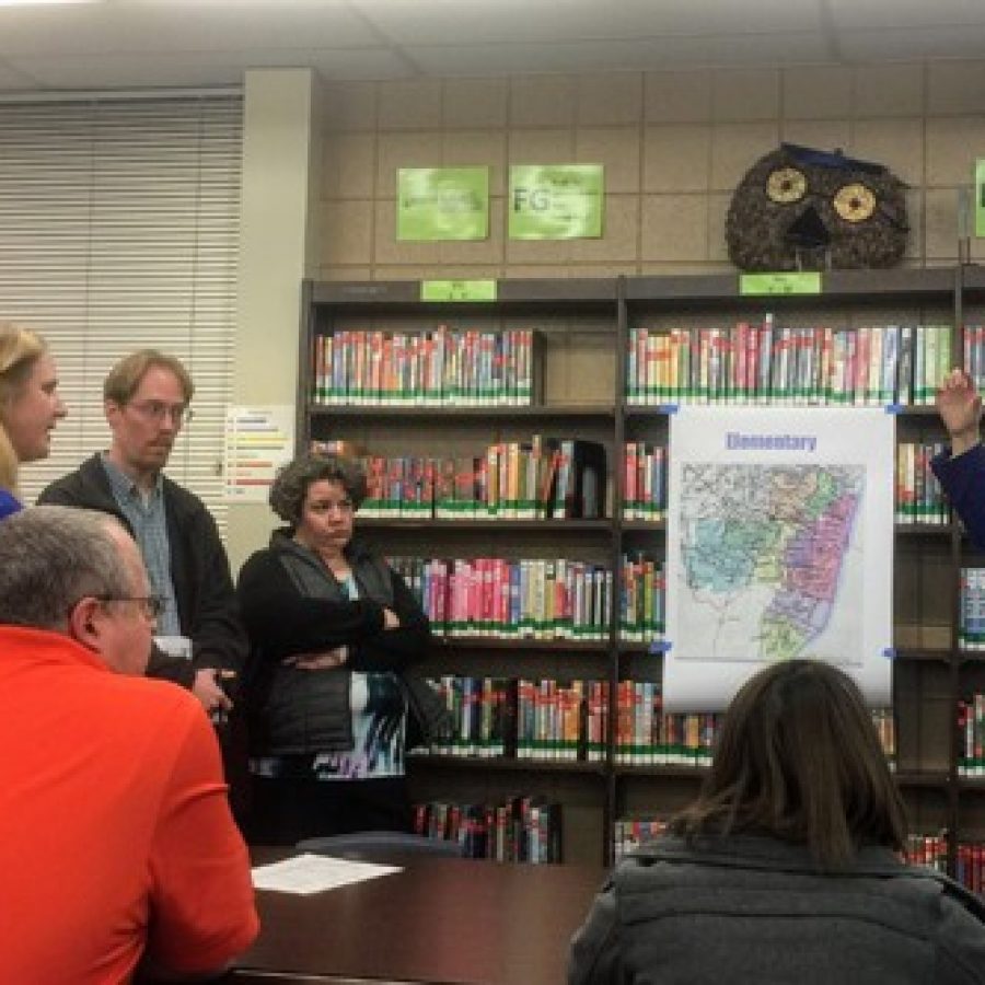 Redistricting Chair Kelly Roberts, right, tells King Arthur Estates resident Jennifer Kiphart, left, that the Redistricting Committee decided that her subdivision could not stay in the Oakville feeder system because it would overload Blades Elementary more than other elementary schools at the March 7 listening session in the Washington Middle School library.