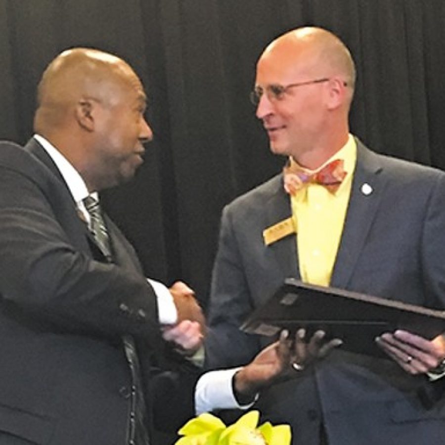 Alton Frailey, retired superintendent of the Katy Independent School District in Katy, Texas, congratulates Mehlville Superintendent Chris Gaines, right, after Frailey installed Gaines as the new president-elect of The School Super-intendents Association, or AASA. Frailey ended his term as AASA president the same day and now serves as past president.