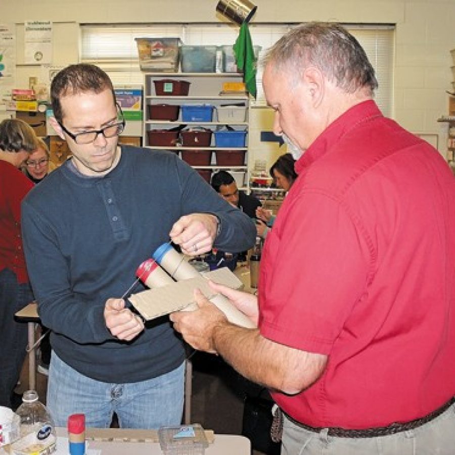 Beasley Elementary School teachers Ben McClusky and Doug Timme create a musical instrument as part of the Science of Learning Instrument Design, or SOLID, Music Project.