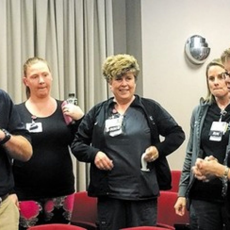 The mother of fallen Officer Blake Snyder, Peggy Snyder, right, a retired nurse, thanks the St. Anthonys Medical Center emergency-room nurses and doctors last week who treated her son after he was shot in the line of duty. Photo by Gloria Lloyd.
 