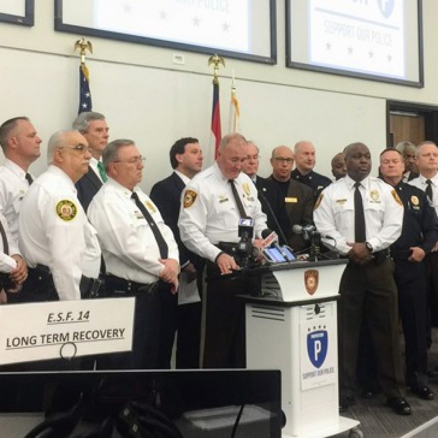 Chief Jon Belmar speaks at the Prop P kickoff event last week, surrounded by police officers and officials including county Prosecuting Attorney Robert McCulloch, County Executive Steve Stenger and Deputy Chief Ken Cox.