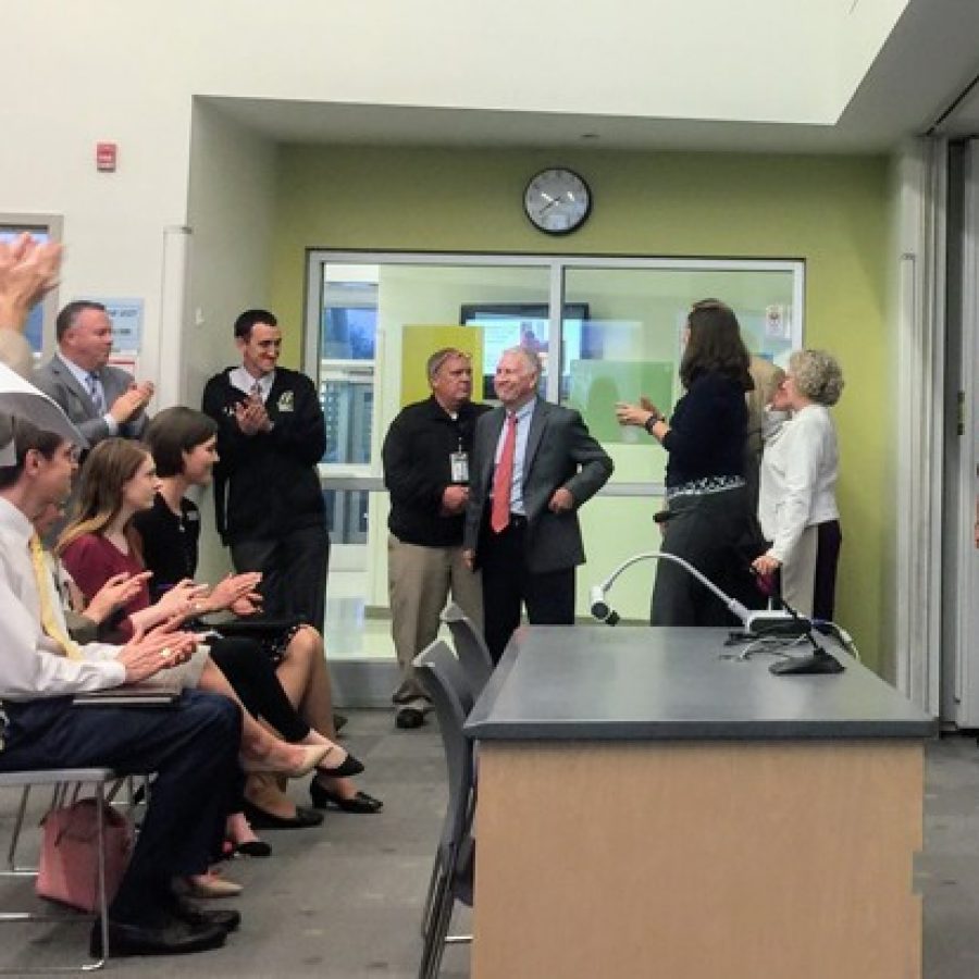 The crowd attending the Lindbergh Board of Education meeting April 11 gives departing member and longtime Lindbergh teacher and coach Don Bee, center, a standing ovation as he leaves the room after the new board is sworn in. Bee is pictured with fellow departing members Vicki Englund, Gary Ujka and Kathy Kienstra. Among those clapping are, from left, board candidate Martha Duchild, Executive Director of Planning and Development Karl Guyer, Communications Director Beth Johnston, Lindbergh High School Principal Eric Cochran and new board member Cathy Lorenz.