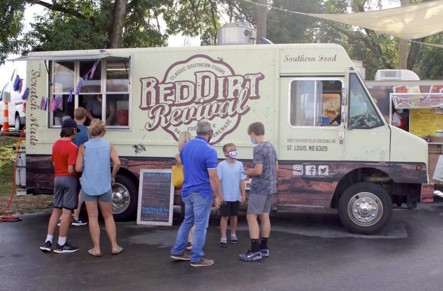 Dinner-goers visit 9 Mile Garden, a food truck garden in Affton July 2020. 