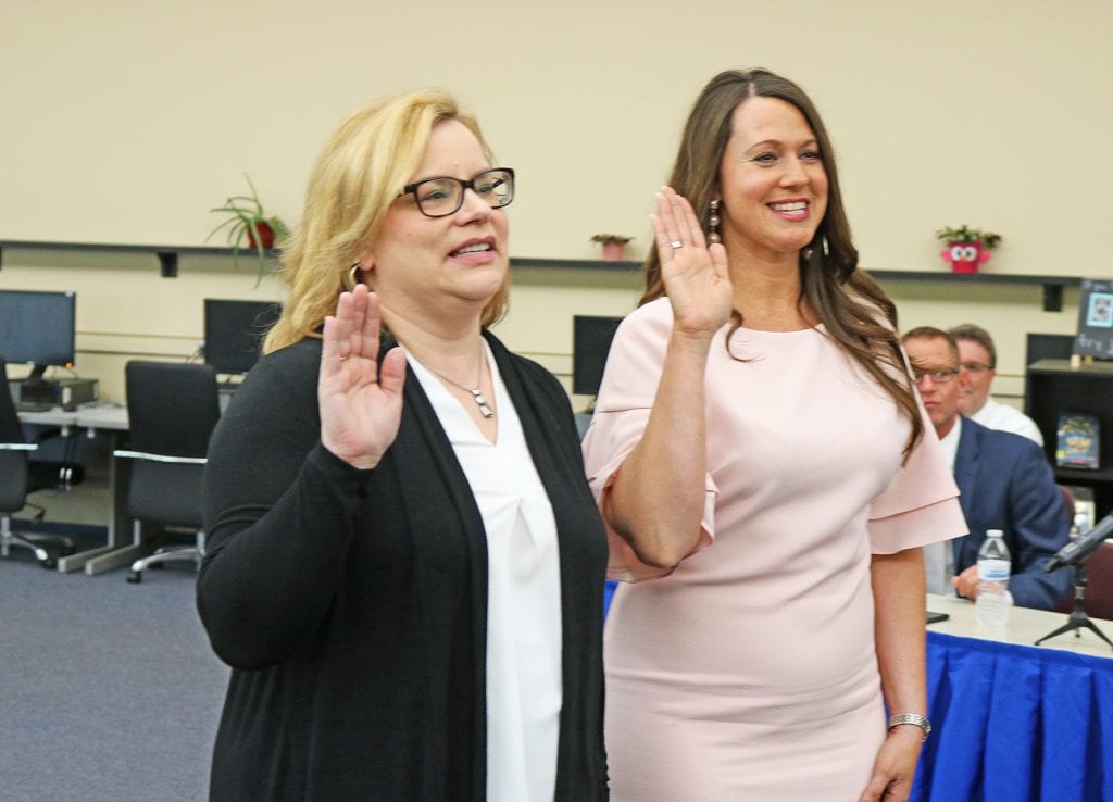 Lisa Messmer, left, and Tori Behlke take their seats on the Mehlville school board in 2018.