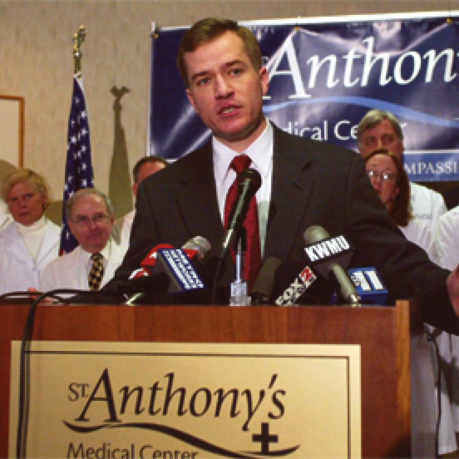 Flanked by doctors at St. Anthonys Medical Center, Gov. Matt Blunt discusses his concerns about tort reform. Blunt, who contends high legal costs are hurting Missouri businesses and forcing doctors in high-risk specialties to quit or move, supports limits on punitive and non-economic damages, restrictions on so-called venue shopping and increased sanctions against unscrupulous attorneys who file frivolous lawsuits. The governor also supports a non-economic damage cap of \$250,000 in medical malpractice cases. 