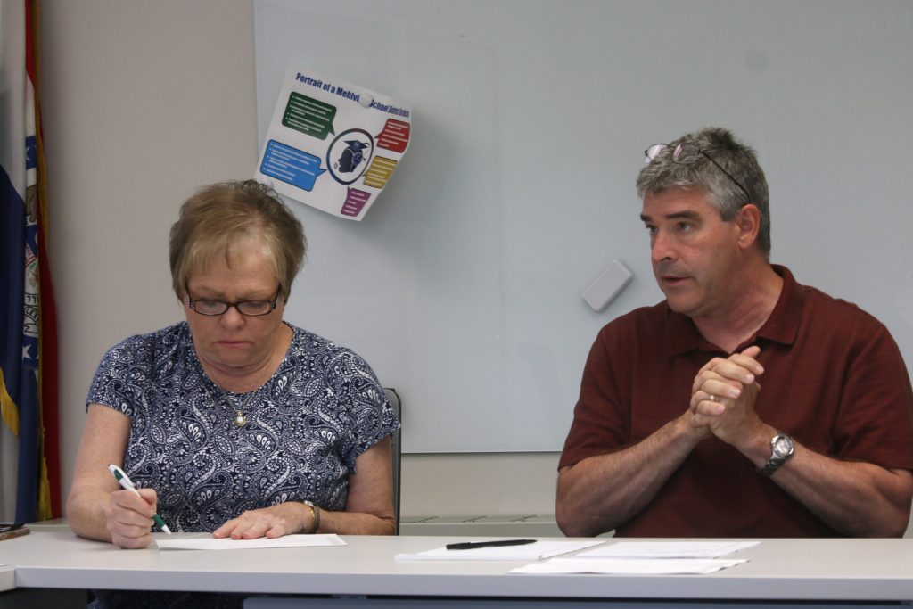 Mehlville Board of Education member Jean Pretto and Chief Financial Officer Marshall Crutcher discuss the 2020 budget during a meeting June 5, 2019 at Mehlville High School.