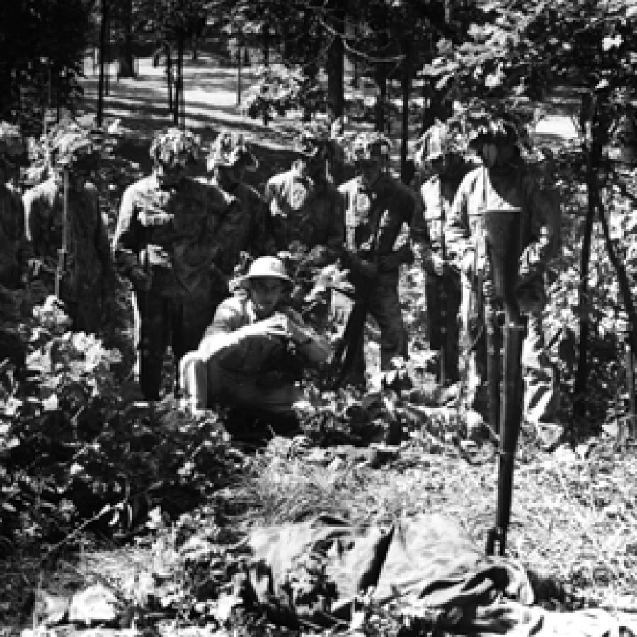 Citizen soldiers get a lesson in camoflage and concealment while stationed at Jefferson Barracks in 1943.