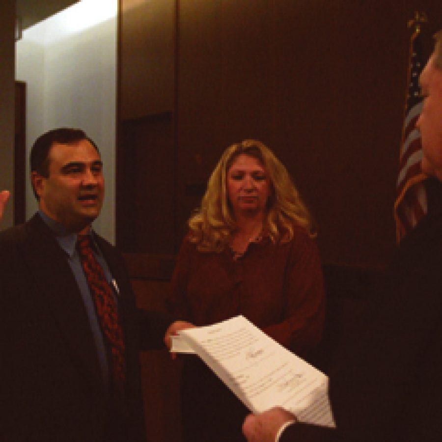 County Councilman John Campisi, R-south county, takes the oath of office Saturday as he is sworn into his second term of office as his wife, Lori, watches. Campisi, first elected to the County Council in 2000, was re-elected in November, defeating Democratic challenger Julie Leicht by more than 7,000 votes. Campisi garnered 41,434 votes compared to Leichts 34,379 votes. Of the 6th Districts 99,022 voters, 79,339 — 80.12 percent — cast ballots.