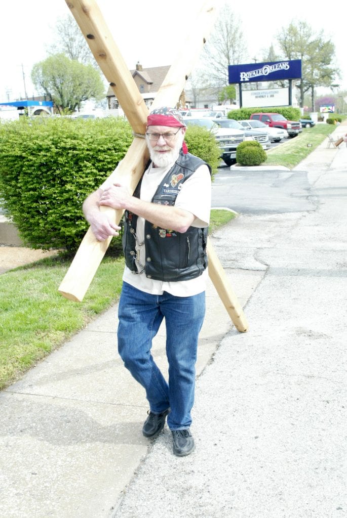 James Laughlin of Oakville carries a cross of his own making along Telegraph Road outside the sanctuary. Photo by Bill Milligan.