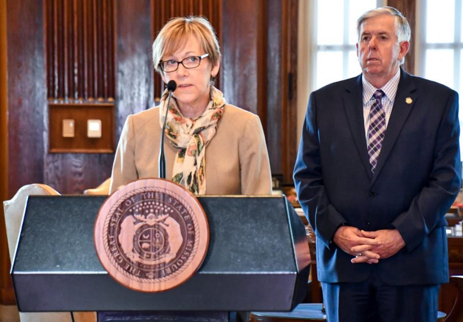 Christine Smith, left, a vice president at Pfizer, details the production and trials that will be happening at Pfizers Chesterfield, Missouri facility, alongside Missouri Gov. Mike Parson. 