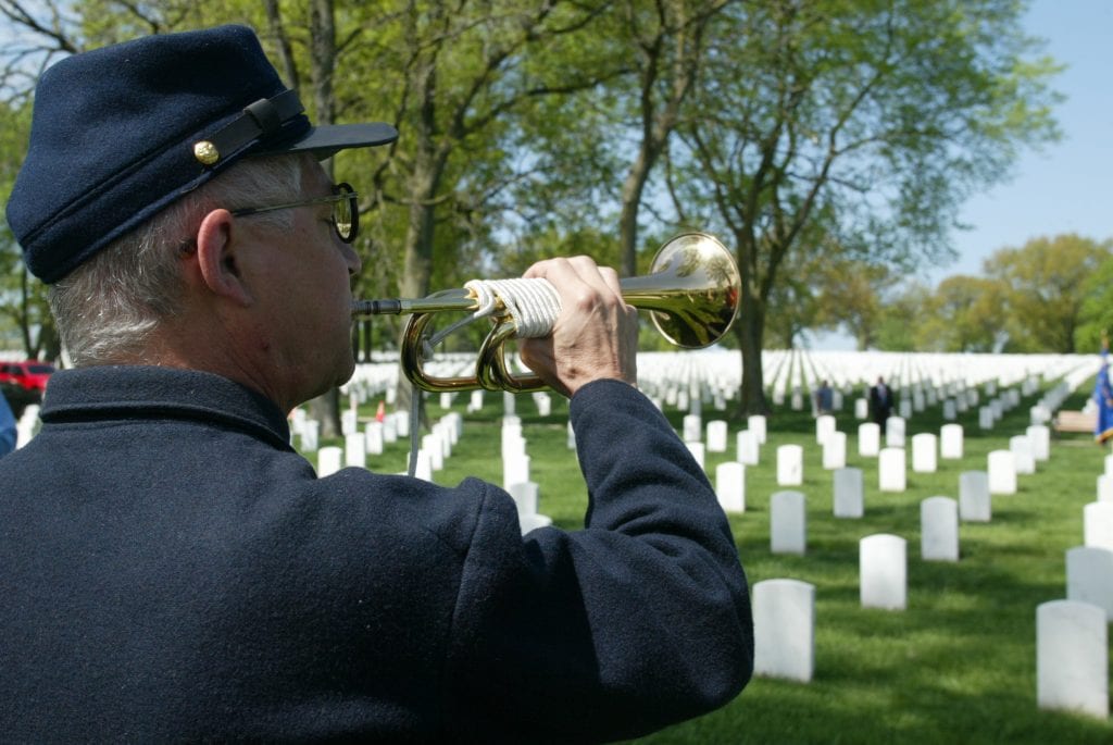 Marc Garcia plays the trumpet at the Jefferson Barracks National Cemetery ceremony. 