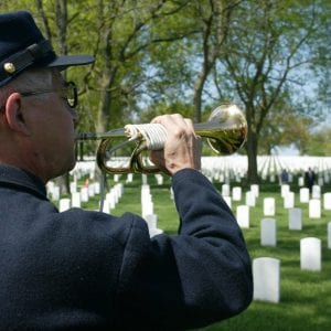 Marc Garcia plays the trumpet during a ceremony at the Jefferson Barracks National Cemetery in 2018.