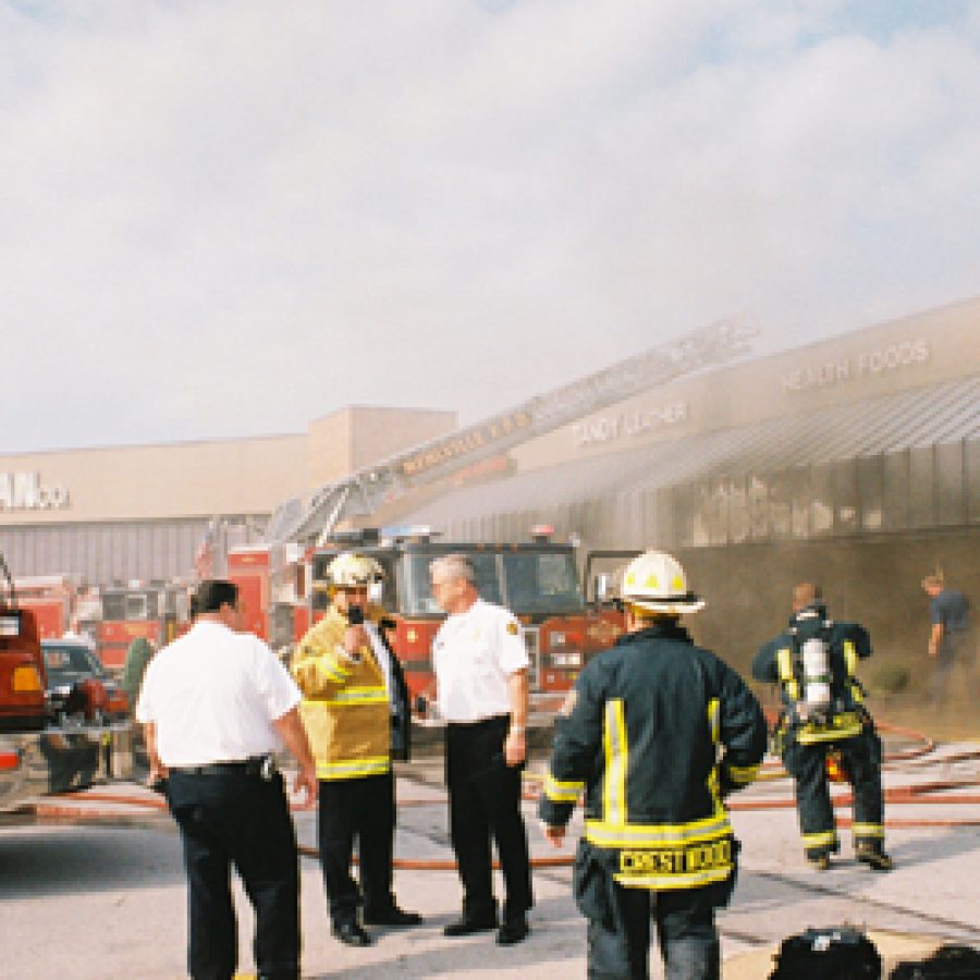 Mehlville Fire Protection District command officers, from left, Phil Minnella, Steve Mossotti and Jim Hampton, direct firefighting operations during the July 19 blaze at Concord Plaza. Also pictured are a pair of unidentified Crestwood firefighters.