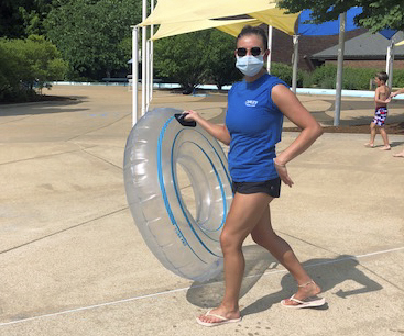 An employee wears a mask at the newly reopened Crestwood pool, as seen June 19.