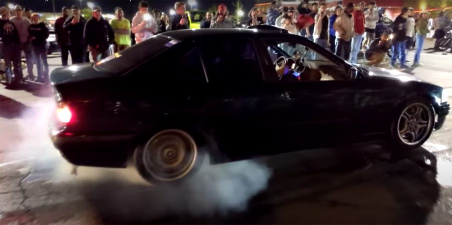 In this still from a YouTube video of the 'Cruisin' Lindbergh' event April 18, a car prepares to do a burnout on the Ronnie's Plaza parking lot as onlookers gather. 