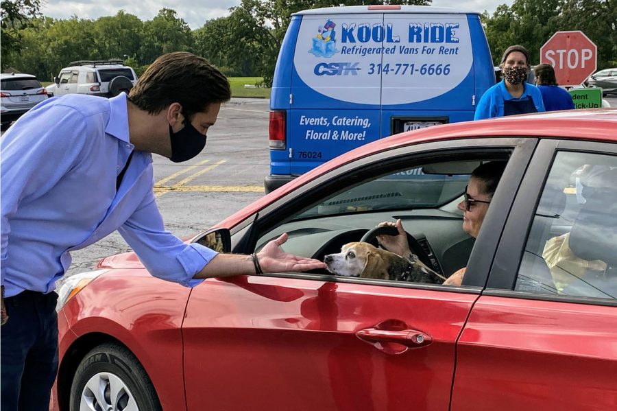 Rep. David Gregory is pictured above meeting a constituent and her dog at a September 2020 food drive event he and Rep. Jim Murphy co-sponsored at Mehlville High School.