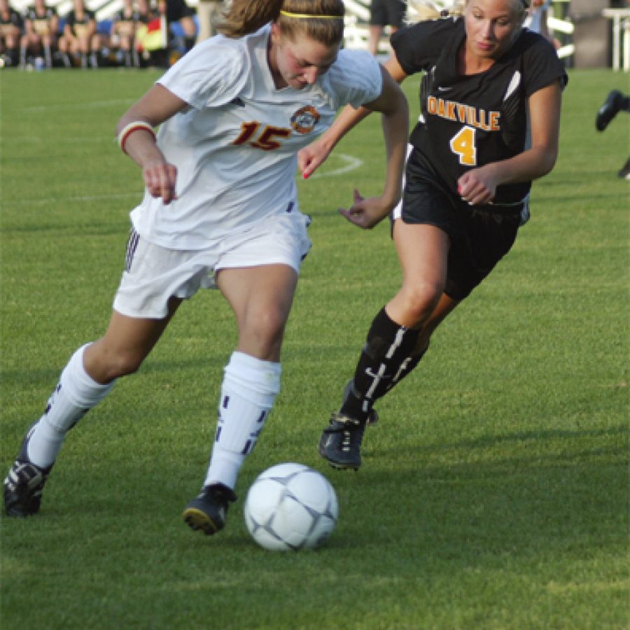 Oakville High senior defender Lauren Dieckmann, No. 4 in the photograph to the left, chases Incarnate Words Jenny Kates, No. 15, to keep her from centering a pass to teammates waiting near the goal Saturday during state semifinal soccer action at Soccer Park in Fenton.