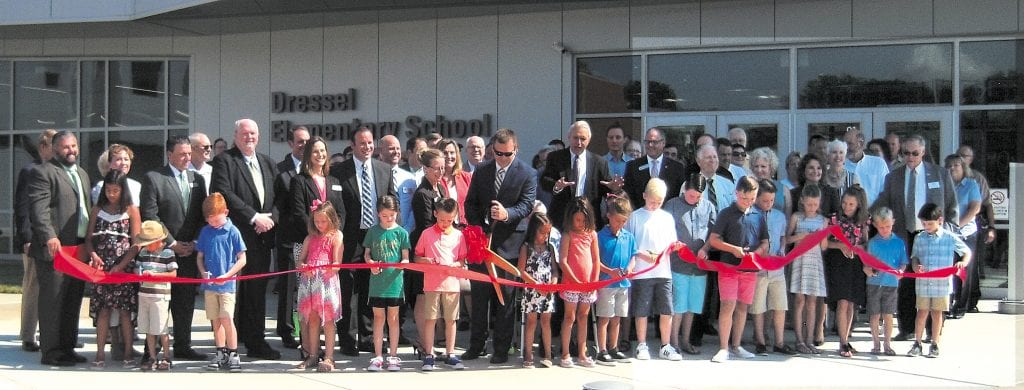 Lindbergh Schools Board of Education members, administrators, teachers and staff gathered last week along with former school board members, state and local elected officials, community leaders and members of the Dressel family to celebrate the opening of the district's 650-student Dressel Elementary School, as Dressel students cut the ribbon for the new state-of-the art school on the direction of Superintendent Jim Simpson, arms extended. Photo by Mike Anthony.