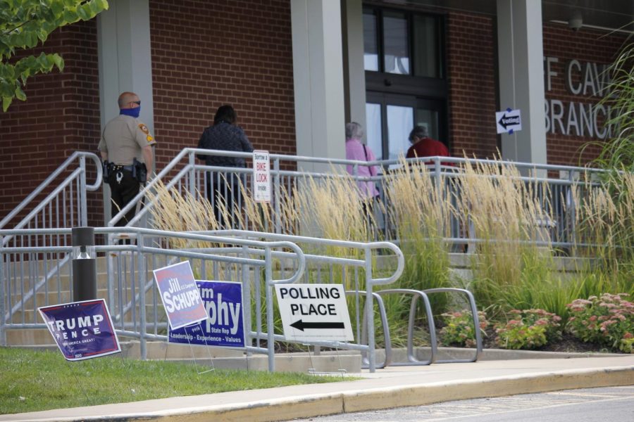 Voters line up outside Cliff Cave Library in Oakville to vote in the 2020 primary election.