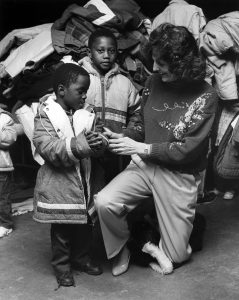 In this photo published by the St. Patrick Center on its 35th anniversary, Edith Cunnane talks to children at the center. 