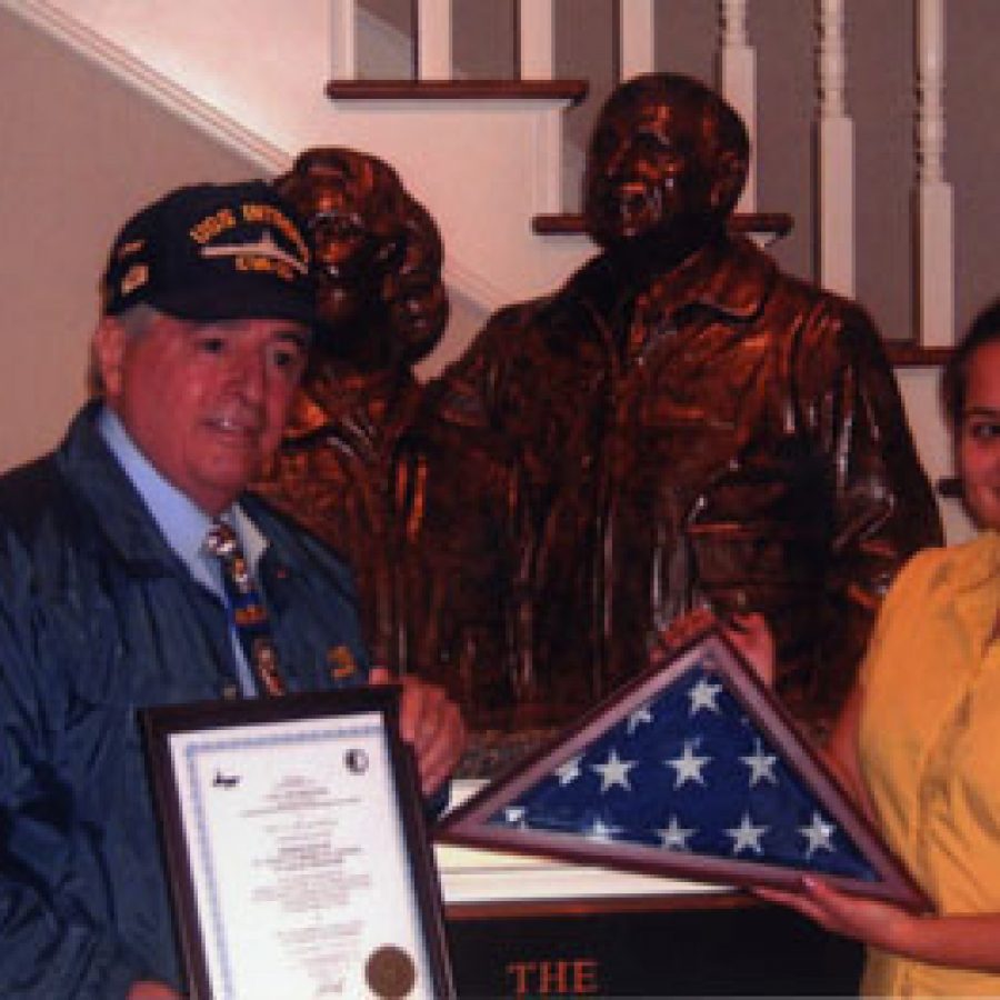 A former crew member of the USS Intrepid last week presented a flag flown on the ship to the St. Louis Fisher House. The late Zachary Fisher and his wife, Elizabeth, founded the Fisher House Foundation and personally dedicated more than \$20 million to the construction of comfort homes for families of hospitalized military personnel. Since opening in July 2010, the St. Louis Fisher House has served as a home away from home for several hundred families of veterans receiving care at the nearby Veterans Affairs Medical Center. In 1978, Zachary Fisher founded the campaign to save the historic and battle-scarred World War II aircraft carrier USS Intrepid from the scrap yard and transform it into Americas largest naval museum. More than 50 Fisher Houses now operate across the United States. Each time a new one opens, a flag flown on the Intrepid is presented to the Fisher House by the Intrepid Former Crew Member Association. Above, Concord resident Alan W. Boyce, who served on the USS Intrepid-CVA-11 for four years, presents the flag and a plaque to Rachael Fer-nandez, manager of the St. Louis Fisher House.