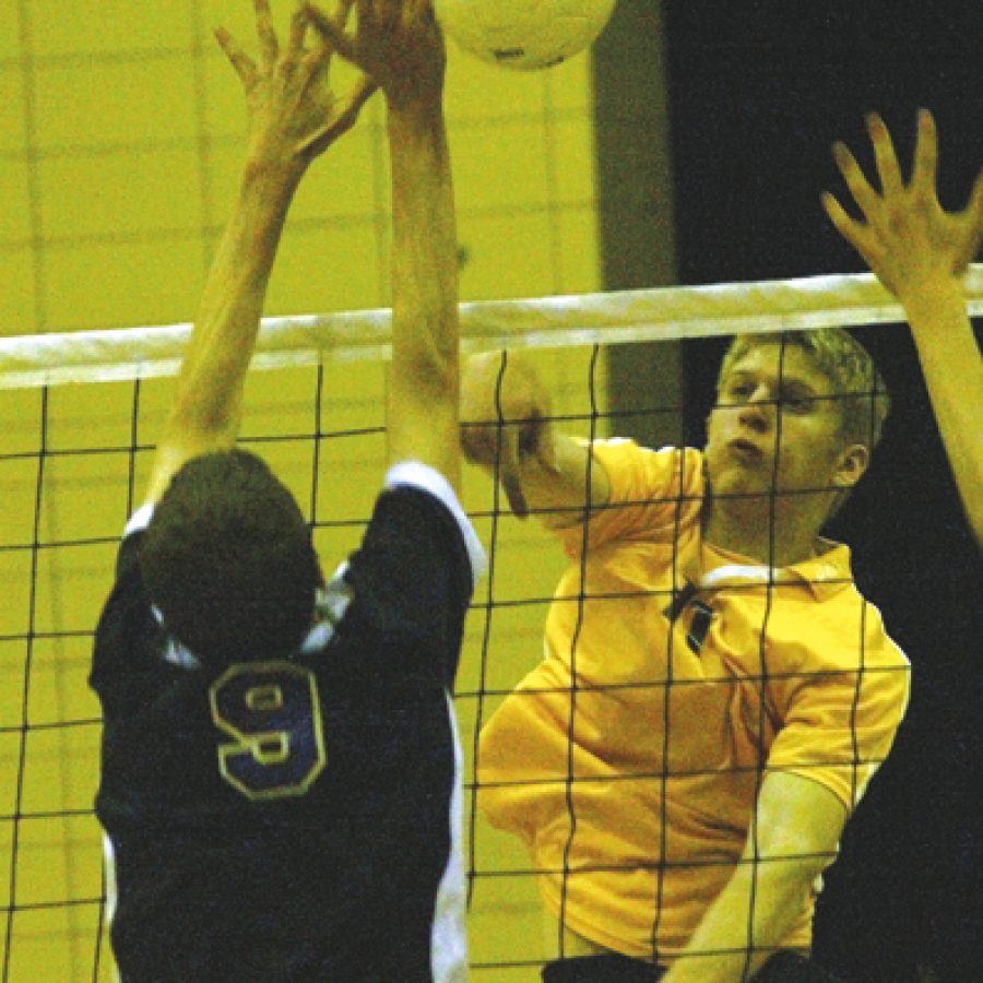 Bill Milligan photo
A shot by Oakvilles J.D. Gasparovic pushes past the outstretched hands of Eureka defender Jordan Crist during a recent volleyball match at Oakville Senior High School. The Tigers advanced to the states Final Four, but lost a close match to Vianney, which eventually won its second straight state championship.