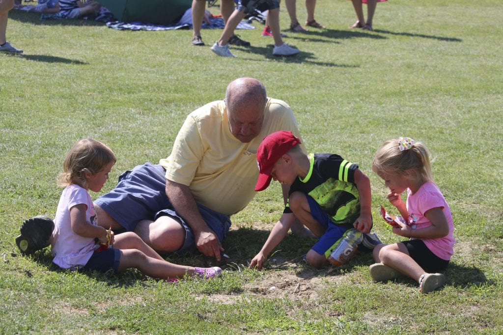 Ed Jackson plays with grandchildren Luke, 4, and twins Emma and Lil, 3, during the Tower Tee farewell concert in July 2018. Photo by Jessica Belle Kramer.