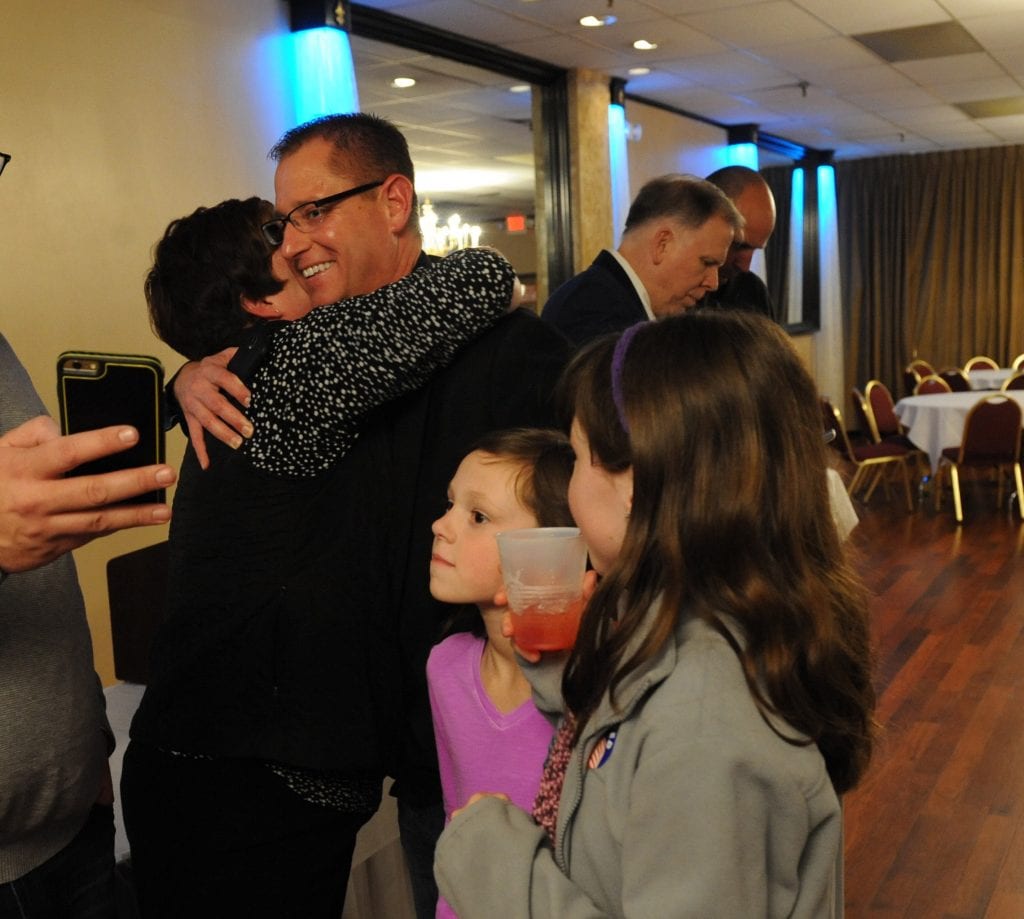 Mehlville Proposition R organizer Kimberly Hanan-West hugs Assistant Superintendent Jeff Bresler after seeing the first results at the Prop R victory party in November 2015. In the background, Superintendent Chris Gaines looks at election results with Dan Fowler. 