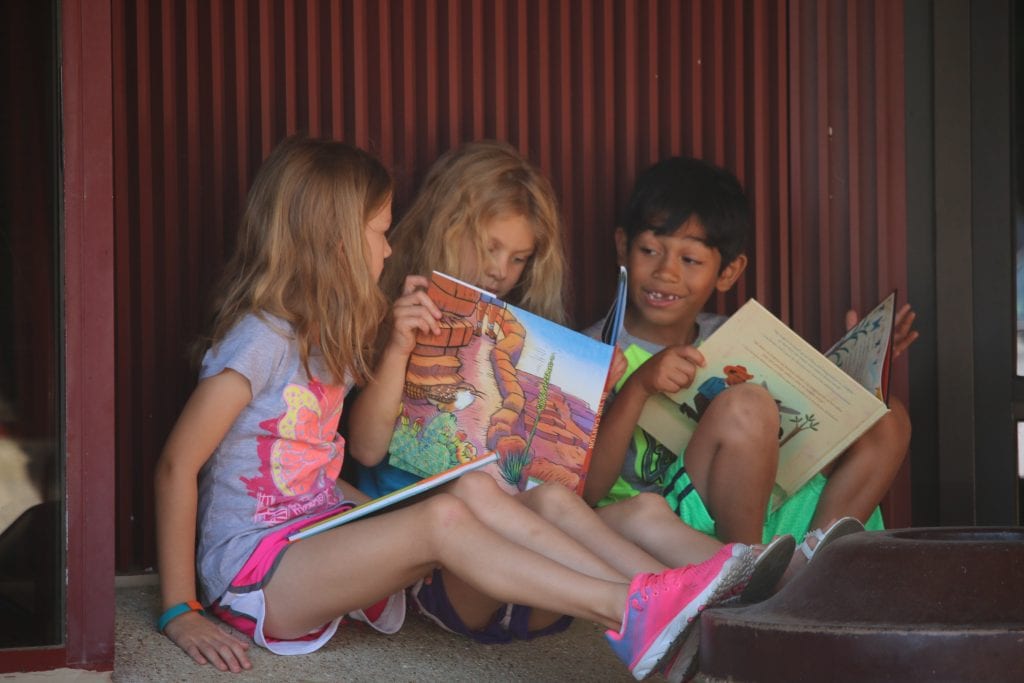 Incoming Hancock second-grader Aubrey-Nicholson, first-grader Makenna Kessler and second-grader Moussa Moftin read their brand new books together at the Bring Me a Book event in summer 2018. Photo by Jessica Belle Kramer.