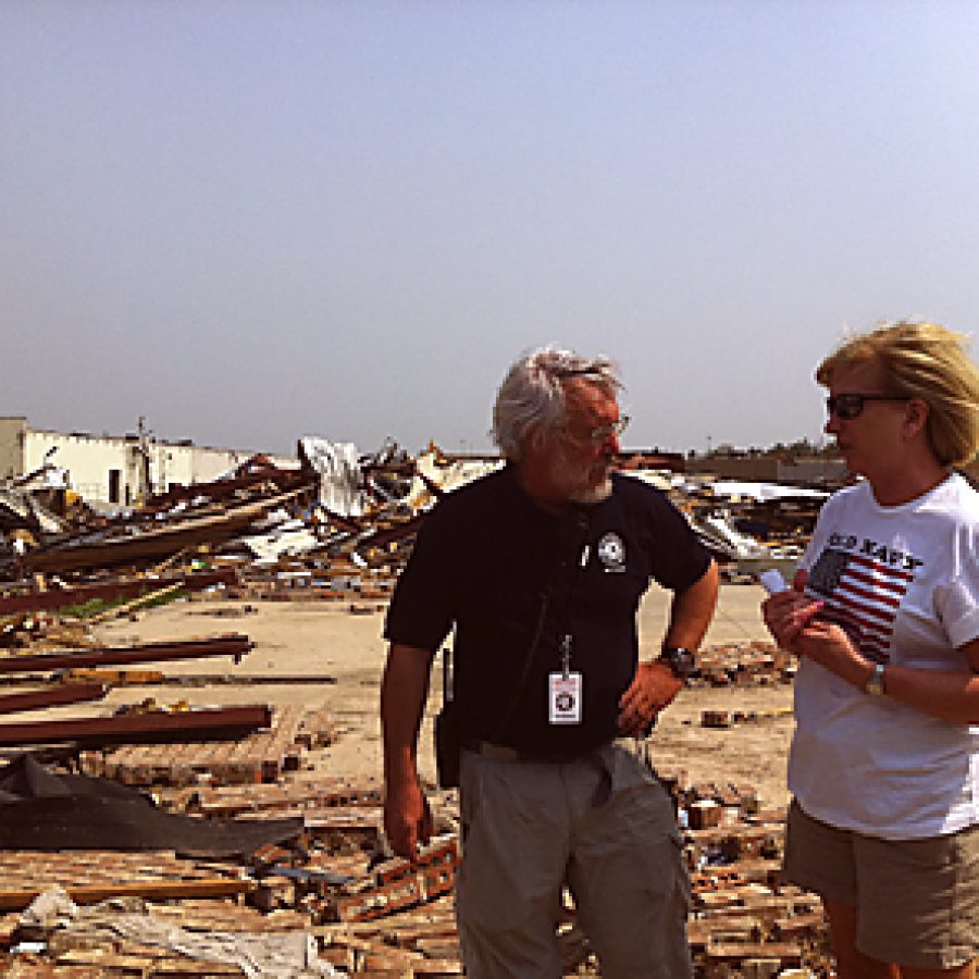 Bruce Bailey, executive director of AmeriCorps St. Louis, discusses the relief ef-forts under way in Joplin with Rep. Marsha Haefner of Oakville.