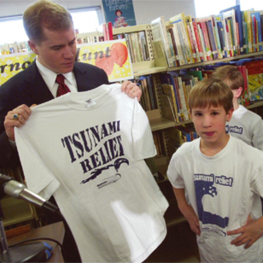 Gov. Matt Blunt holds a T-shirt given to him by pupils at Trautwein Accel-erated School last week. Blunt donated more than \$11,000 to the Mehlville School Districts tsunami relief effort. The money was left over from Blunts inauguration fund.