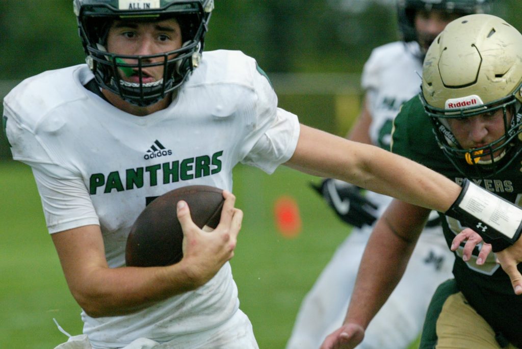 Mehlville+Panthers+quarterback+Evan+Robertson+takes+the+ball+from+the+Flyers+in+the+rain-delayed%2C+mud-soaked+game+in+September.+Photo+by+Bill+Milligan.+