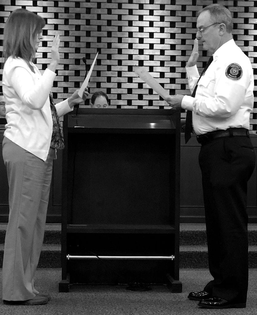 City clerk Helen Ingold administers the oath to new Fire Chief Lou Hecht at the Crestwood Board of Aldermen meeting Nov. 13. Hecht is taking over the role of fire chief after former Chief David Oliveri moved to Washington state to become fire chief of the town of Anacortes. Photo by Erin Achenbach.