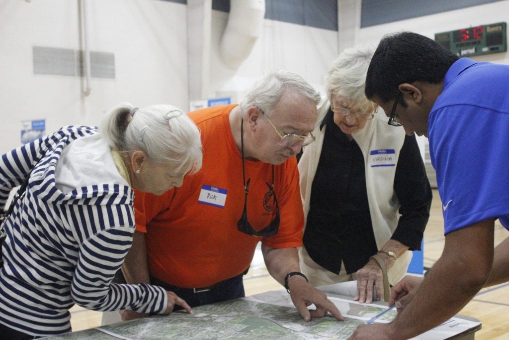An Ameren spokesperson helps residents find where they live on a map and their proximity to the project at a 2018 open house. The project is scheduled to be complete by winter 2021. Photo by Erin Achenbach. 
