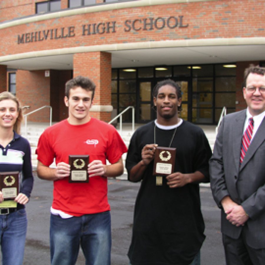 Mehlville Senior High Schools Athletes of the Month are presented their plaques by Ed Harris of Edward Jones. Pictured, from left, are: Rachel Heet, Denaldin Hamzagic, Rodney Heard and Harris.