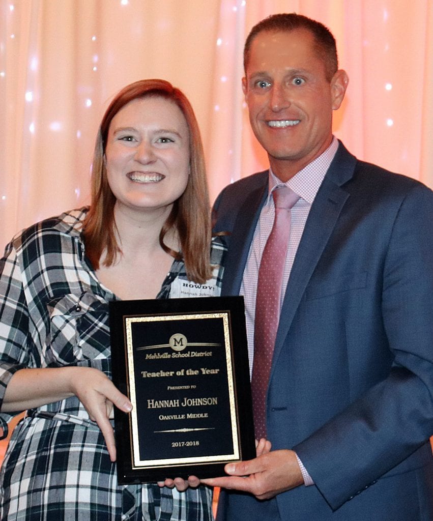 Oakville+Middle+School+teacher+Hannah+Johnson%2C+left%2C+is+honored+by+Assistant+Superintendent+Jeff+Bresler+as+the+Mehlville+Teacher+of+the+Year+at+the+District+Recognition+Night+April+26.