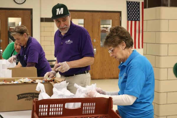 Mehlville School District employees, seen above March 23, are handing out grab-and-go meals of breakfast and lunch to all children living in the Mehlville School District during the extended closure. The meals are available at seven sites. 