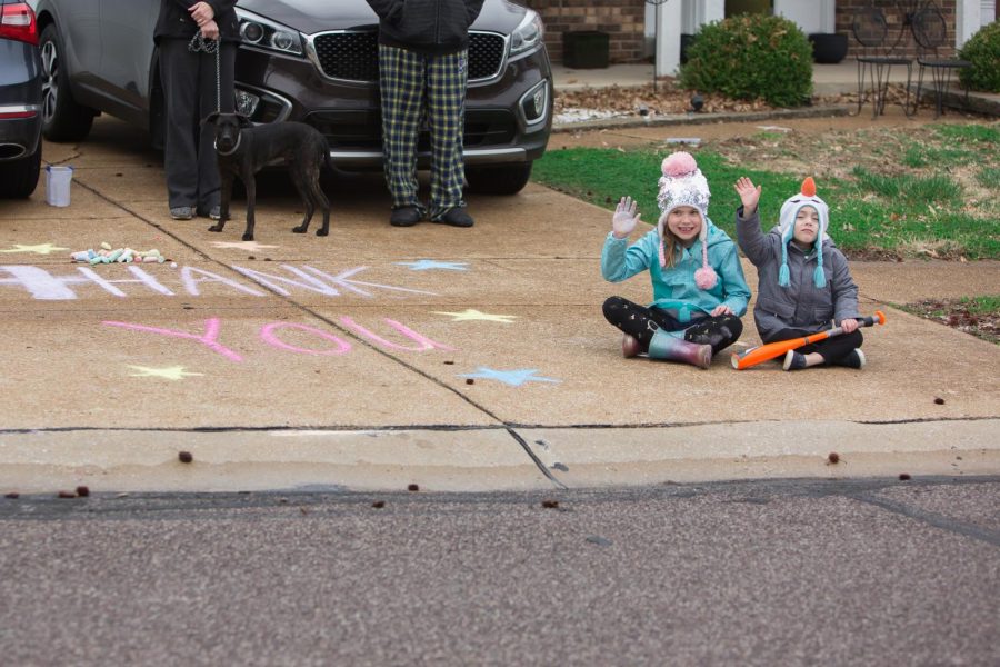 Students at Wohlwend Elementary in Oakville, above, along with Rogers and Forder, stood
outside their houses Sunday to wave as their teachers drove by in a parade.