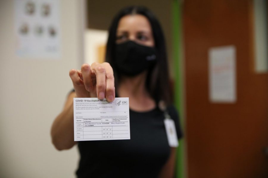 Mercy Hospital South Chief Medical Officer Dr. Aamina Akhtar displays a COVID-19 vaccination card, which states where and when an individual received the COVID-19 vaccine. The Pfizer vaccine requires two doses administered roughly three weeks apart. 