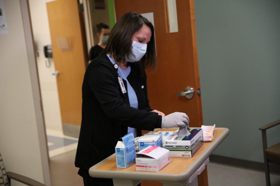 A nurse at Mercy Hospital South prepares the first dose of Pfizer/BioNTechs COVID-19 vaccine for Mercys Chief Medical Officer Aamina Akhtar Monday, Dec. 14, 2020. Mercy South planned to vaccinate 20 workers Dec. 14 and another 20 staffers Dec. 15. 