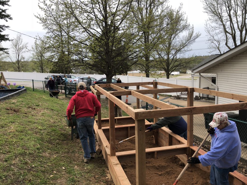 Volunteers from Faith Lutheran Church and the Oakville Garden Club spread donated topsoil and mulch in the newly constructed garden. Topsoil, mulch and plants were donated for the garden by local nurseries.
