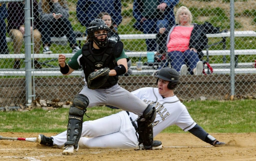 Oakville’s Hunter Iffland slides home safely as Mehlville catcher Carmen Fuller awaits the throw from his defense in a March 2019 game.