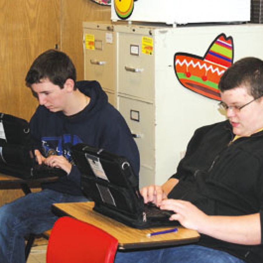 Then-freshmen Tyler Fendler, left, and Paul Suntrup, students in Allison Brauns communications arts class at Mehlville Senior High, are shown with the laptops they received for the districts One-to-One Open Source Pilot Program.