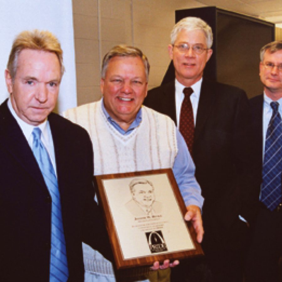 Joseph Rinke accepts a plaque for his more than nine years of service as owner co-chairman of Productivity and Responsibility Increase Development and Em-ployment of St. Louis Inc. Pictured, from left, are: Gerald Feldhaus, Rinke, Scott Wilson and Richard Schaefer.