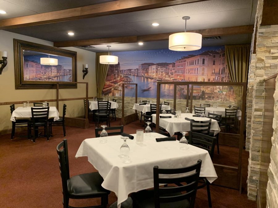 Shields block individual tables from one another at Robertos Trattoria, using Plexiglas barriers in June 2020.