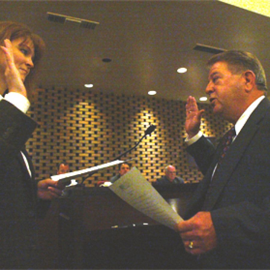 Crestwood City Clerk Kimberly Cottle administers the oath of office to the citys new mayor, Roy Robinson, during last weeks Board of Aldermen meeting.