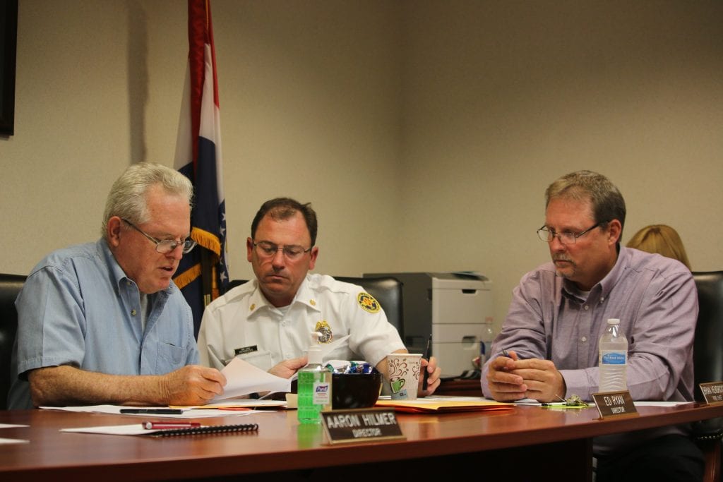 Secretary Ed Ryan and Fire Chief Brian Hendricks go over the payment of bills with Archimages associate Roy Mangan in 2018.