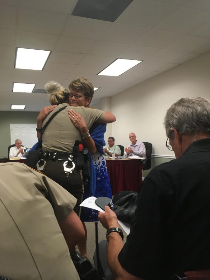 A St. Louis County Police Officer embraces Peggy Snyder, Officer Blake Snyders mom, at a Green Park meeting August 2018. 
